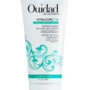 Close-up of a bottle of Ouidad's Vitacurl Define & Shine Styling Gel-Cream against a transparent background.