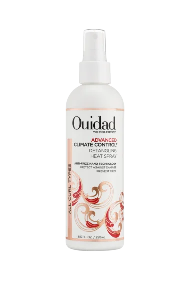 Close-up of a bottle of Ouidad Detangling Heat Spray curly hair product against a transparent background.