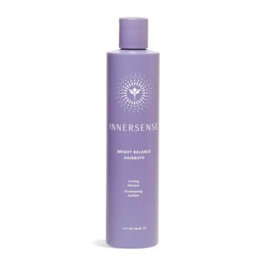 Close-up of a 10 ounce purple bottle of Innersense Bright Balance Hairbath toning shampoo, against a white background.