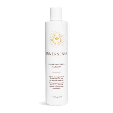 Close-up of a 10 ounce white bottle of Innersense Color Awakening Hairbath shampoo, against a white background.