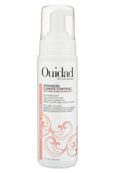 Close-up of a bottle of Ouidad Featherlight Volumizing Foam curly hair product against a transparent background.