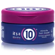 Close-up of a blue container with a purple lid of it's a 10 miracle hair mask for curly hair, against a white background.