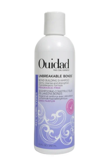 Close-up of a bottle of Ouidad Unbreakable Bonds Bond Building Shampoo against a transparent background.